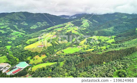 Stunning and Beautiful Aerial View of Lush Green Hills and Majestic Mountains Beyond Stunning and Beautiful Aerial View of Lush Green Hills and Majestic Mountains Beyond 139624968