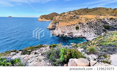 A Serene Coastal Landscape Featuring Clear Blue Waters, Scenic Rocky Cliffs, and Natures Wonder 139625073