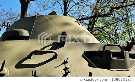 A military tank positioned in a natural setting, showcasing its robust design and functionality A military tank positioned in a natural setting, showcasing its robust design and functionality 139625185
