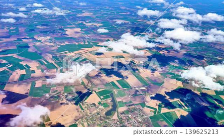 A breathtaking aerial landscape view showcasing vast fields and fluffy clouds in the sky A breathtaking aerial landscape view showcasing vast fields and fluffy clouds in the sky 139625213