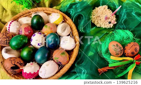 Bright and Colorful Easter Eggs Alongside a Beautifully Decorated Basket for the Holiday Bright and Colorful Easter Eggs Alongside a Beautifully Decorated Basket for the Holiday 139625216