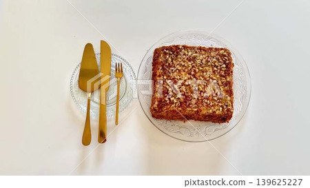 A Scrumptious Dessert Featuring Luxurious Golden Cutlery Against a Clean White Background 139625227