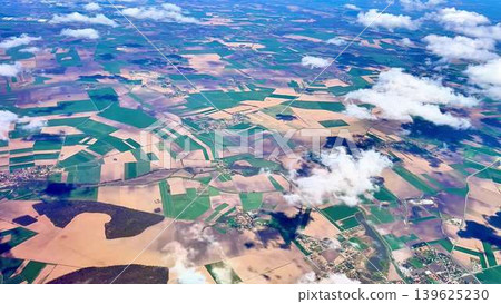 Stunning Aerial View Capturing the Vibrant Agricultural Landscapes Underneath a Cloud Cover Stunning Aerial View Capturing the Vibrant Agricultural Landscapes Underneath a Cloud Cover 139625230