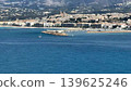 Experience the stunning coastal view of a picturesque Mediterranean town by majestic mountains 139625246