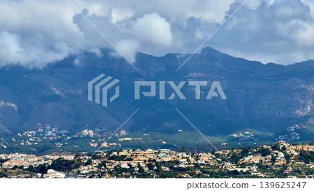 Stunning Mountain Landscape featuring vibrant Cloud Cover amidst Residential Areas and serenity Stunning Mountain Landscape featuring vibrant Cloud Cover amidst Residential Areas and serenity 139625247