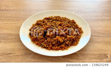 A delicious and spicy Jollof Rice dish featuring a mix of vibrant vegetables and tender chicken A delicious and spicy Jollof Rice dish featuring a mix of vibrant vegetables and tender chicken 139625249