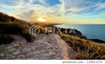 Experience a Serene Coastal Sunset A Scenic Path to Explore by the Beautiful Ocean Experience a Serene Coastal Sunset A Scenic Path to Explore by the Beautiful Ocean 139625254