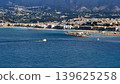Breathtaking Coastal View Featuring Sailboats Sailing Amidst the Vibrant City Skyline 139625258