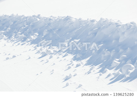 Curved edge of white snow on groomed ski slope Curved edge of white snow on groomed ski slope 139625280