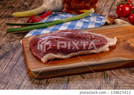 Raw duck breast on wooden board with fresh ingredients 139625412