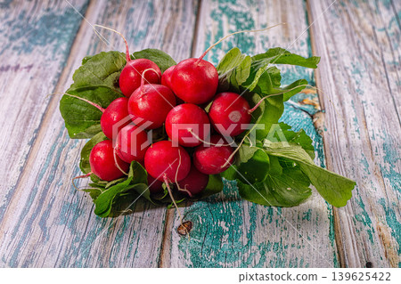 Fresh Red Radishes with Green Leaves on Rustic Wooden Background Fresh Red Radishes with Green Leaves on Rustic Wooden Background 139625422