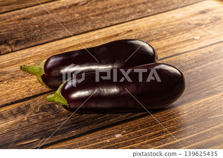 Fresh purple eggplants on rustic wooden background 139625435