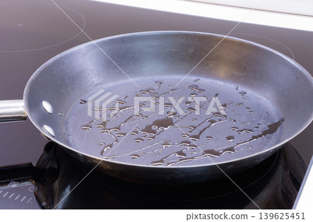 Cooking oil in a black non-stick fry pan Cooking oil in a black non-stick fry pan 139625451