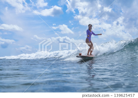 Selfassured Female Effortlessly Rides Bright Ocean Currents Selfassured Female Effortlessly Rides Bright Ocean Currents 139625457
