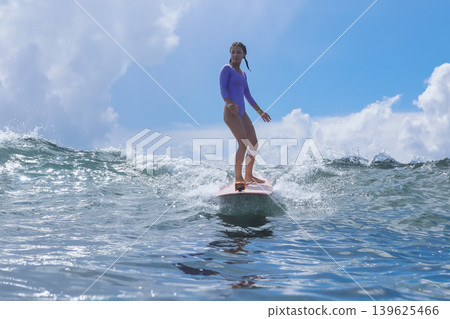 Young Lady With Composed Stance Amidst Peaceful Sea And Clear Sky Backdrop Young Lady With Composed Stance Amidst Peaceful Sea And Clear Sky Backdrop 139625466
