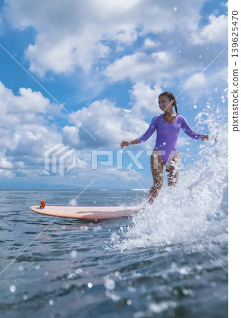 Girl Enjoys Longboard At Coast, Youthful Lady Rides Longboard Near Sunny Waves Girl Enjoys Longboard At Coast, Youthful Lady Rides Longboard Near Sunny Waves 139625470