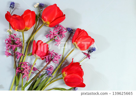 Abstract floral composition and banner for the screen.Still life with spring tulips, muscari, hyacinths, forgetmenots and bird cherry against an elegant background. A floral holiday card Abstract floral composition and banner for the screen.Still life with spring tulips, muscari, hyacinths, forgetmenots and bird cherry against an elegant background. A floral holiday card 139625665