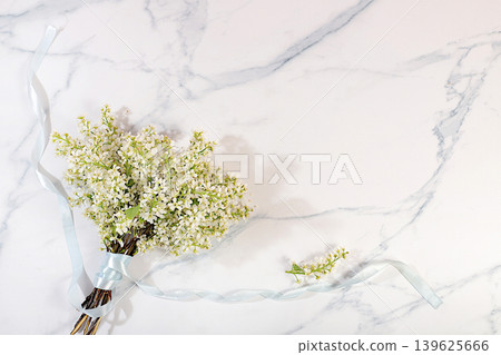Still life with a bouquet of spring bird cherry branches on an elegant background.Abstract floral arrangement and banner for the screen A floral holiday card with a summer greeting, design template Still life with a bouquet of spring bird cherry branches on an elegant background.Abstract floral arrangement and banner for the screen A floral holiday card with a summer greeting, design template 139625666