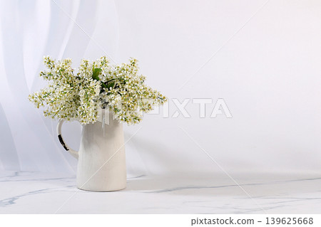 Abstract floral arrangement and banner for the screen. A still life with beautiful spring branches of blooming bird cherry in a vase against an elegant background. A floral holiday card Abstract floral arrangement and banner for the screen. A still life with beautiful spring branches of blooming bird cherry in a vase against an elegant background. A floral holiday card 139625668