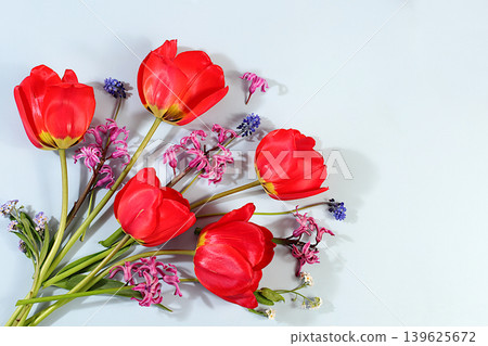 Abstract floral composition and banner for the screen.Still life with spring tulips, muscari, hyacinths, forgetmenots and bird cherry against an elegant background. A floral holiday card Abstract floral composition and banner for the screen.Still life with spring tulips, muscari, hyacinths, forgetmenots and bird cherry against an elegant background. A floral holiday card 139625672