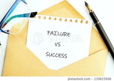 A white paper with FAILURE VS SUCCESS written on it emerges from an open brown envelope A white paper with FAILURE VS SUCCESS written on it emerges from an open brown envelope 139625686