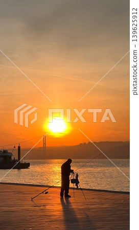Silhouette of a man and child fishing at sunset on a waterfront Silhouette of a man and child fishing at sunset on a waterfront 139625912