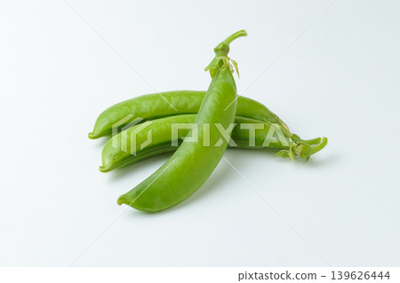 Three snap peas arranged in a three-dimensional way against a white background. Three snap peas arranged in a three-dimensional way against a white background. 139626444