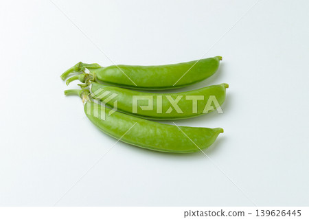 A photograph of three snap peas lined up against a white background. A photograph of three snap peas lined up against a white background. 139626445