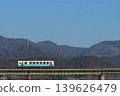A KiHa 32 series diesel railcar crosses a railway bridge with the majestic Shikoku Mountains in the background. (Photographed on February 21, 2026) 139626479