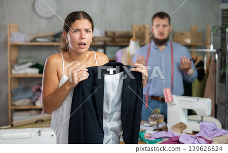 Disappointed customer reacting to defect in custom-made jacket Disappointed customer reacting to defect in custom-made jacket 139626824