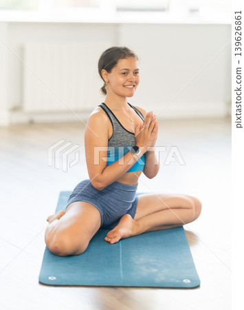 Sporty young woman practicing yoga in serene studio Sporty young woman practicing yoga in serene studio 139626861