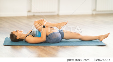 Young woman practicing vinyasa yoga in studio Young woman practicing vinyasa yoga in studio 139626883