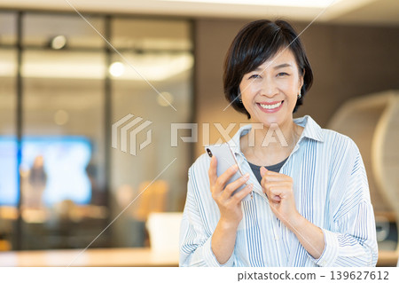 Senior woman operating a smartphone Senior woman operating a smartphone 139627612