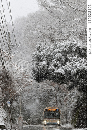 A bus running through a snow-covered forest A bus running through a snow-covered forest 139628101