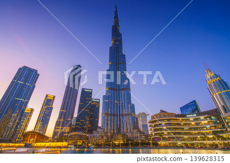 Dubai, United Arab Emirates - Jan 19 2024, panoramic view of the Burj Khalifa Tower from below, at nighttime with illumination and street lights, Dubai, UAE Dubai, United Arab Emirates - Jan 19 2024, panoramic view of the Burj Khalifa Tower from below, at nighttime with illumination and street lights, Dubai, UAE 139628315
