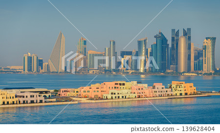 Doha, Qatar- Jan 14 2024, Panoramic  view of the Mina District, part of the port of Doha and long pier, with skyscrapers and buildings in the background, at daytime, Doha, Qatar 139628404
