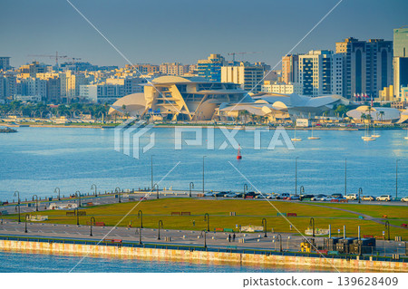 Doha, Qatar- Jan 14 2024, Aerial view of the narrow pier with lots of seagulls and albatrosses sitting and flying around, Port of Doha, at daytime, Doha, Qatar  139628409