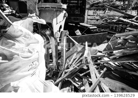 Demolition site of a wooden house and heavy machinery d-5 monochrome Demolition site of a wooden house and heavy machinery d-5 monochrome 139628529