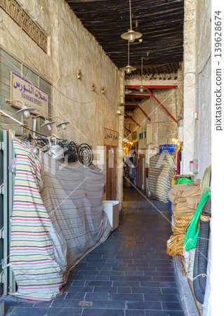 Doha, Qatar - Jan 14 2024, Panoramic view of the narrow market street with shops covered with canvas, in Souq Waqif bazaar, at daytime, Doha, Qatar Doha, Qatar - Jan 14 2024, Panoramic view of the narrow market street with shops covered with canvas, in Souq Waqif bazaar, at daytime, Doha, Qatar 139628674