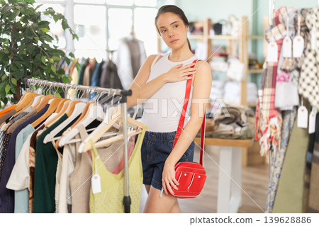 Young women choosing handbag in store Young women choosing handbag in store 139628886