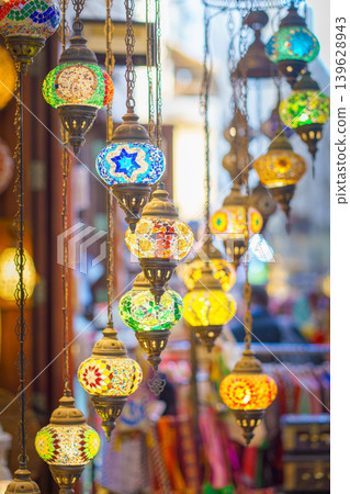 Manama, Bahrain- Jan 15 2024, Close-up view of multicolored antique glass lamps and lanterns with patterns, in souvenir shop, at Souq Bab Al Bahrain, the background is blurred, Manama, Bahrain  139628943