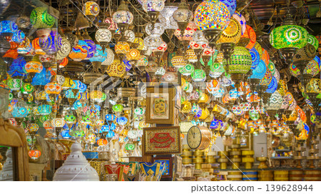 Manama, Bahrain - Jan 15 2024, Panoramic view the interior of the ceiling of a souvenir shop hung with many colorful glass lamps with patterns, at Souq Bab al Bahrain Bazaar, Manama, Bahrain Manama, Bahrain - Jan 15 2024, Panoramic view the interior of the ceiling of a souvenir shop hung with many colorful glass lamps with patterns, at Souq Bab al Bahrain Bazaar, Manama, Bahrain 139628944