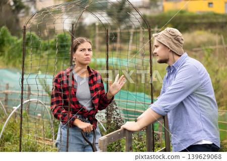 European woman and man neighbors quarrel and swear at village European woman and man neighbors quarrel and swear at village 139629068