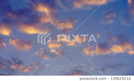 Panoramic view of colourful cumulus clouds against a blue sky at dawn 139629218