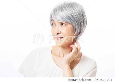 A senior woman looks happy because her skin is in good condition. A senior woman looks happy because her skin is in good condition. 139629705