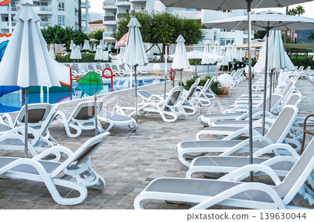 Swimming pool with sun loungers and umbrellas at a resort in Protaras, Cyprus for a relaxing se Swimming pool with sun loungers and umbrellas at a resort in Protaras, Cyprus for a relaxing se 139630044