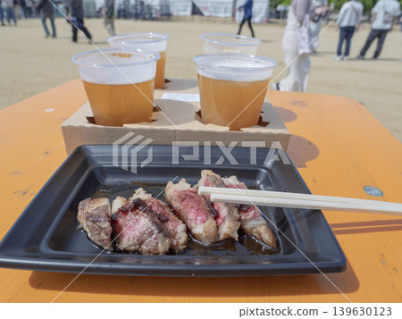 A blissful holiday! Enjoying delicious meat and beer at a festival. 139630123