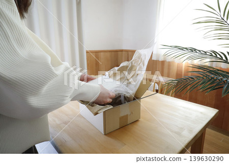 Unpacking in a living room with a natural interior. Unpacking in a living room with a natural interior. 139630290