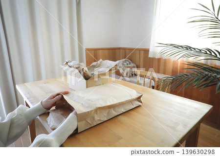 Unpacking in a living room with a natural interior. Unpacking in a living room with a natural interior. 139630298