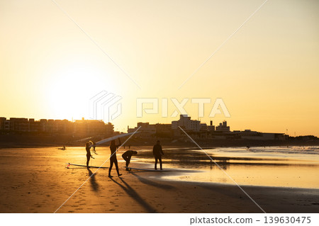 湘南久沼海灘:日出時分,衝浪者走向大海。 湘南久沼海灘:日出時分,衝浪者走向大海。 139630475